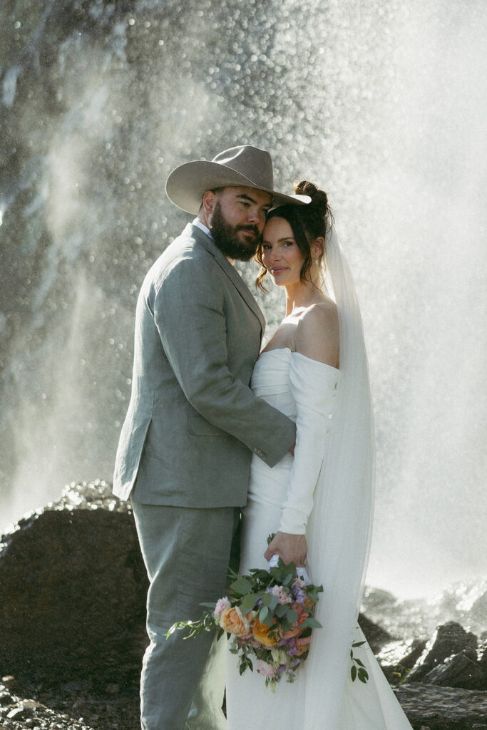 Bride and groom eloping in a waterfall in glacier national park