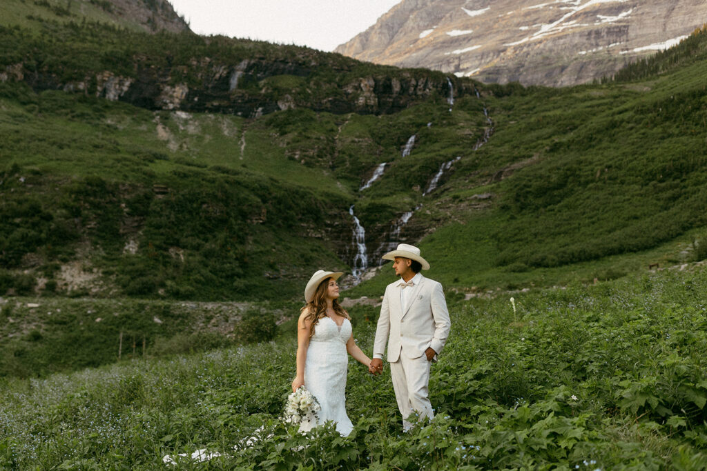 A couple holding hands at Big Bend in after eloping with their friends and families