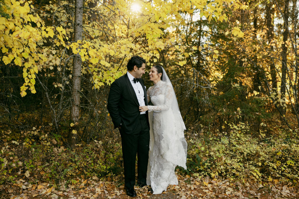 Bride and Groom laugh together after their wedding ceremony at Lake McDonald