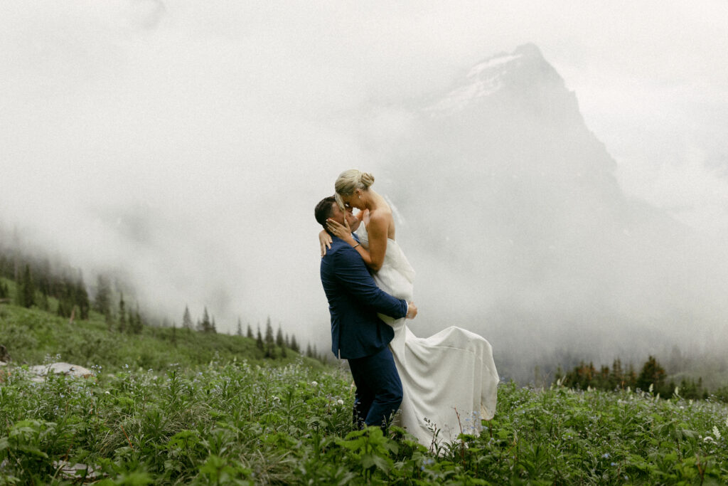 Bride and Groom eloping in a cloud in Glacier National Park