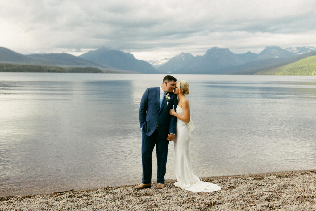 Couple snuggles up together at Lake McDonald