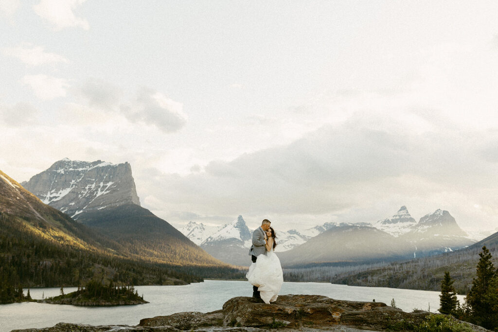 Bride and Groom embrace the wind at Sun Point for their elopement