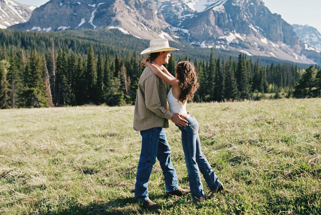 Couple in Glacier National Park pose for their engagement session photos